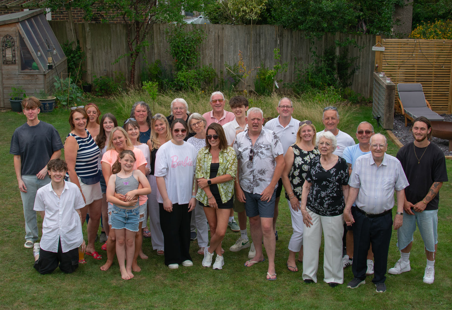 Group of people posing for a photo in a back garden setting ready to wear chances clothing smiley dice clothes