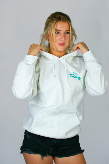 Woman wearing a white hoodie with a green smiley Dice logo on the front with "The Chances Co" written next to it on a grey background